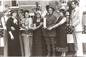 First Place winners in the Bicentennial Float for Civic Groups--Flatwoods FCE. Leo Dotson (Civil War soldier), Glenda James (suffragette wanting women to be able to vote), Dexter Webster (Clara Barton), Linda Skelton, Nell Graves (pioneer woman), Mary Tom Westbrooks (World War I soldier), Ann Laster (Sacagawea), unknown man in funky plaid suit (who presented the trophies, I think). Mary Tom Westbrooks won first place for the most original costume (because it was an original), the World War I uniform of Dr. Earl Boyce.
